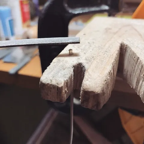 If you don’t own a miter jig (which is an amazing tool btw) but would like an easy way to support a wire while you file it...