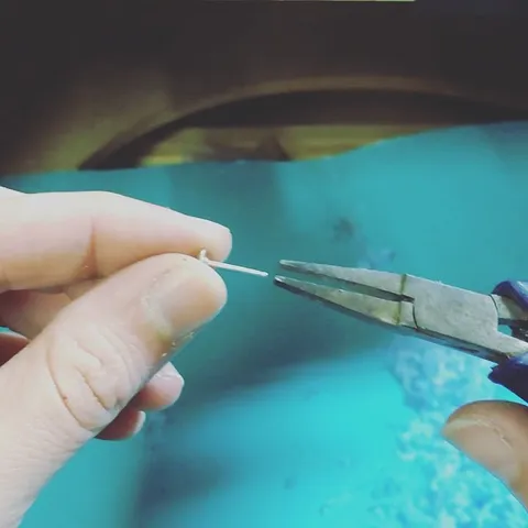 This is a trick for getting your ear posts work hardened after soldering, take your pliers and give them a little twist!...