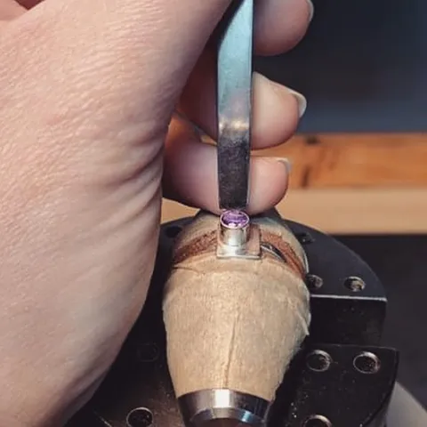 Here is some solid advice on setting bezels from @annperryjeweller - If you're hammer setting start on the "North"  side...