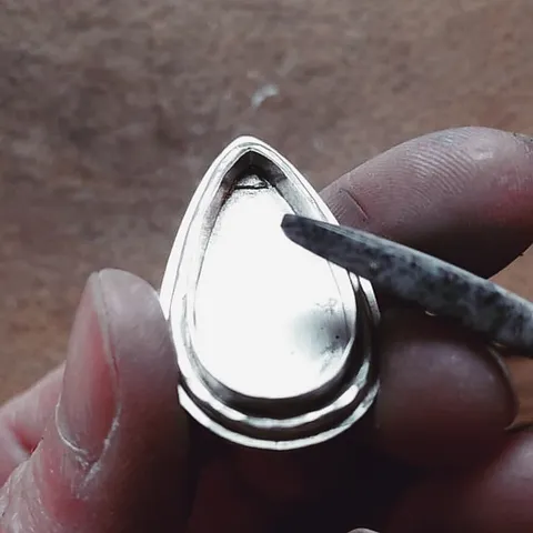 Here is a technique you can use if you have a cabochon that is rocking a bit (due to an uneven bottom ) in its setting...