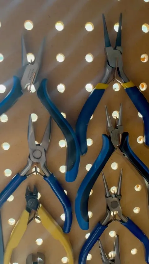 Here is an organization tip from @catina_studionichedesgins if you have a peg board you can make little hooks for your...