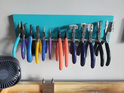 This is a wall mounted plier organization tip from @inspiringadornmentsbyjen - “ I painted a piece of pine wood (4" x 14"...