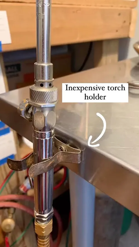 Here is how @margauxlangejewelry holds their torch. “ I secured my torch to my soldering station with a simple metal broom...